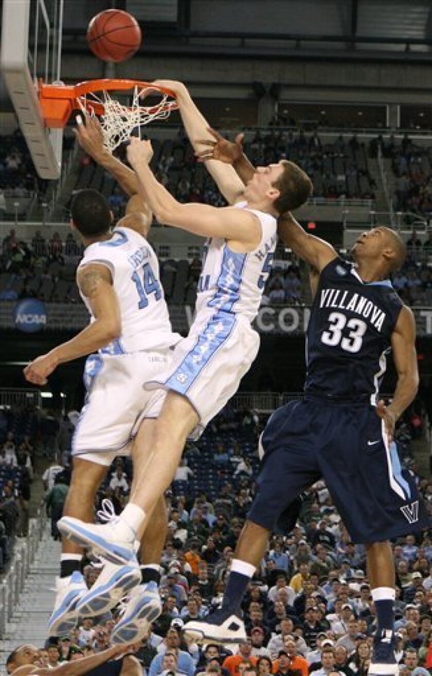 North Carolina's Tyler Hansbrough, center, and Danny Green, left, battle for the ball with Villanova's Dante Cunningham (33) during a men's NCAA Final Four semifinal college basketball game, Saturday, April 4, 2009, in Detroit. (AP Photo/Paul Sancya)
