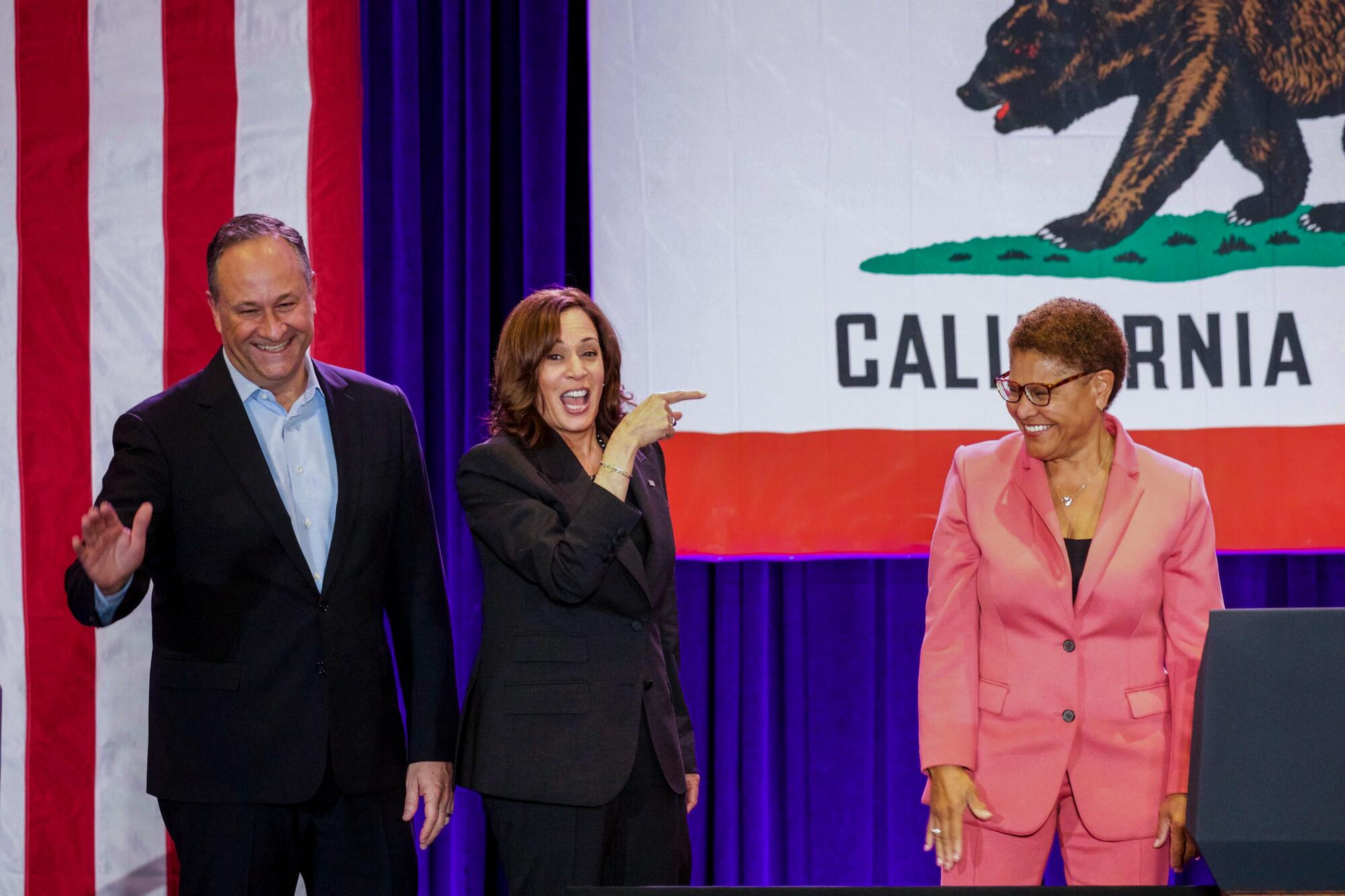 Rep. Karen Bass, right, with Vice President Kamala Harris, center, and Second Gentleman Douglas Emhoff at a rally.