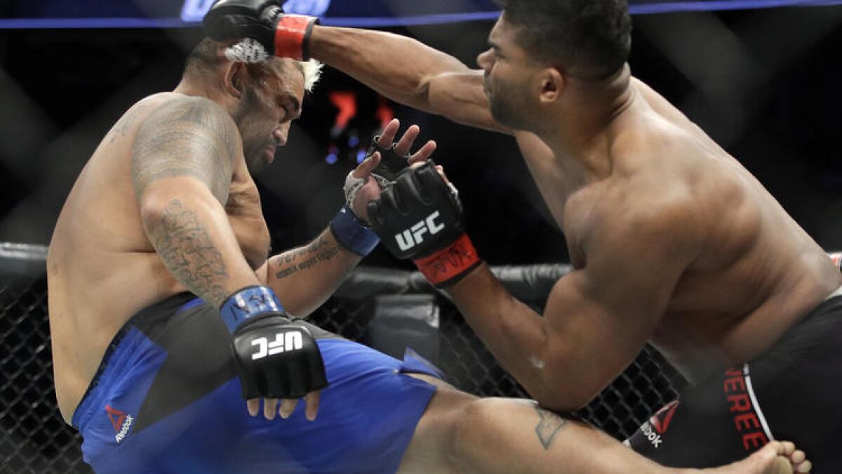 Mark Hunt, left, and Alistair Overeem trade strikes during their fight at UFC 209.