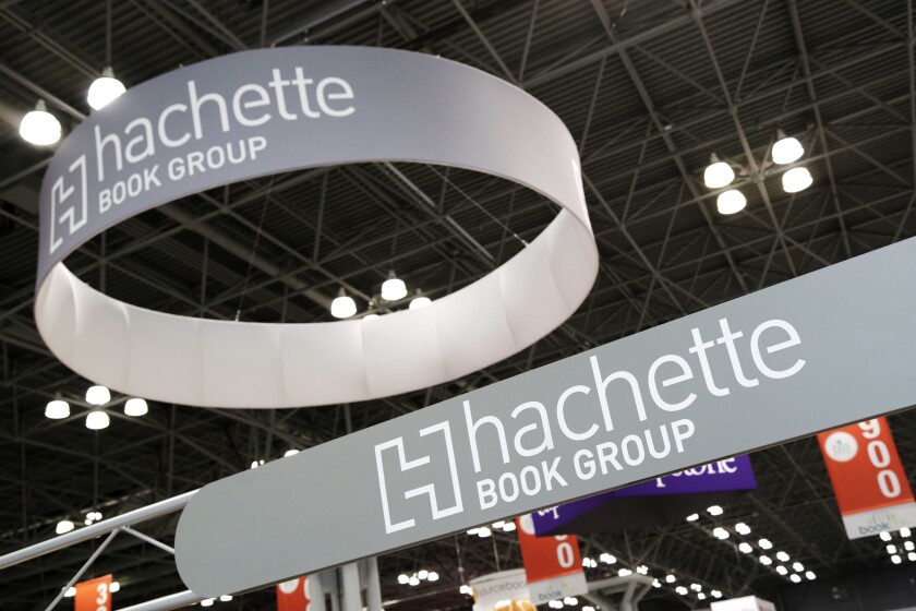FILE - In this May 28, 2015 file photo, signs for Hachette Book Group are displayed at BookExpo America in New York. The annual publishing convention and trade show, a decades-old tradition, may be coming to an end. ReedPop, which has managed BookExpo for a quarter century, announced Tuesday that it was dropping the event, along with the fan-based BookCon. (AP Photo/Mark Lennihan, File)