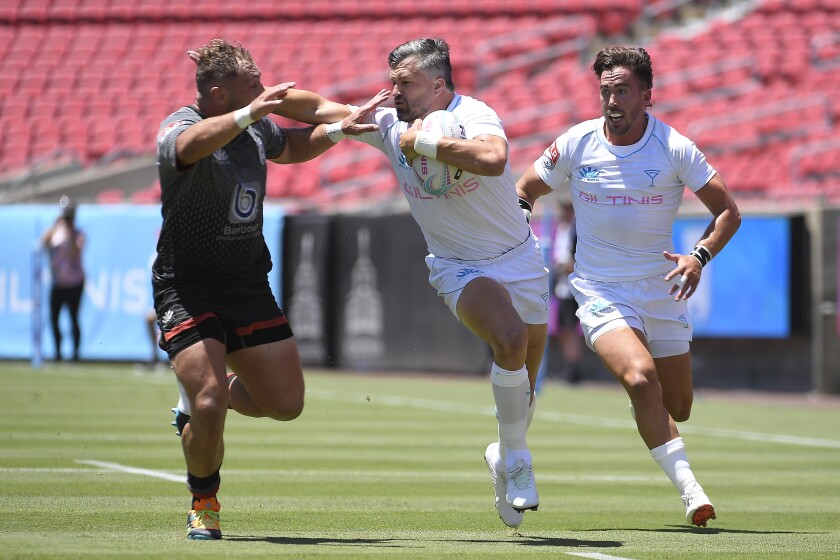 The Giltinis' Adam Ashley-Cooper tries to fend off a Rugby ATL player.