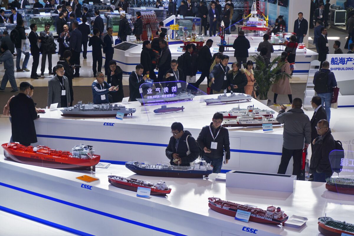 Visitors look at the ship models exhibited by the China State Shipbuilding Corp. (CSSC) during the Marintec China exhibition in Shanghai earlier this month.