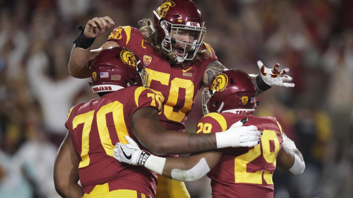 USC's Vavae Malepeai, right, celebrates his touchdown with Chuma Edoga, left, and Toa Lobendahn during the first half against Washington State on Sept. 21.