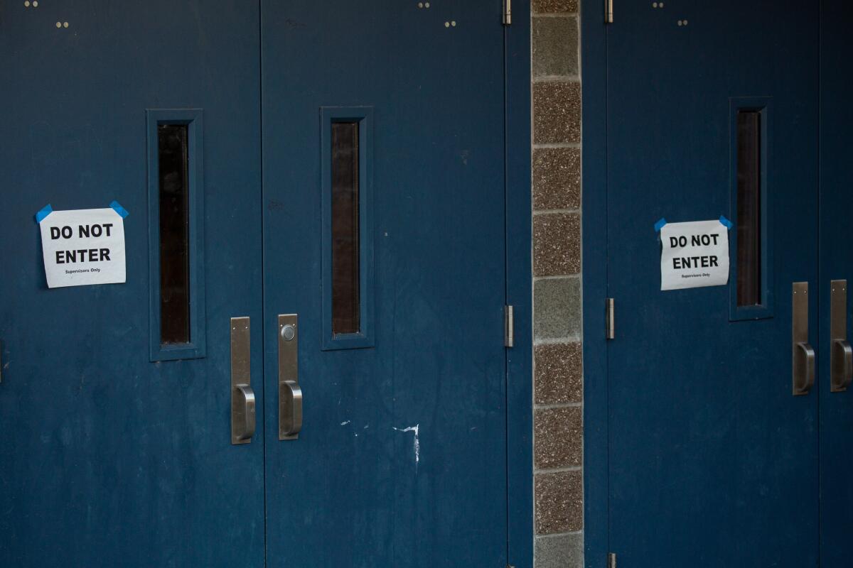 "Do Not Enter" signs mark the doors to Bothell (Wash.) High School.