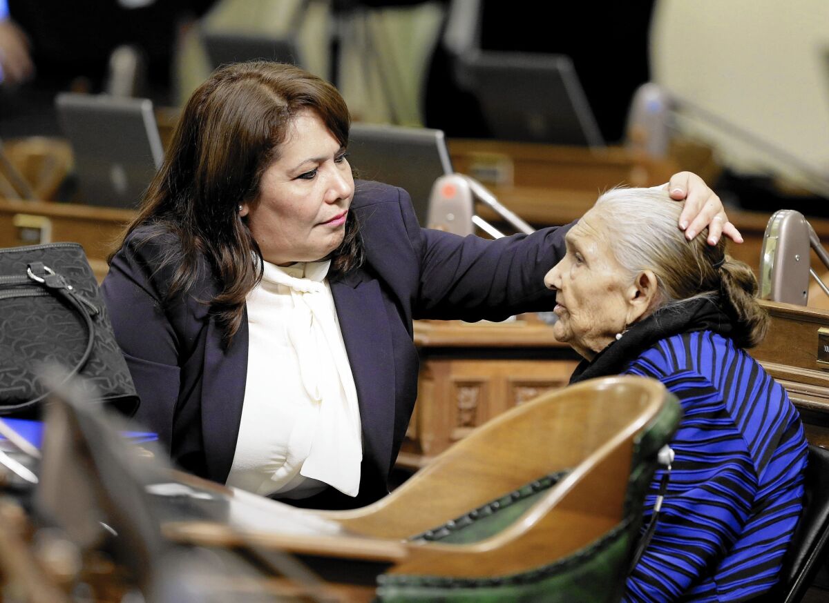 Freshman Assemblywoman Patty Lopez (D-Arleta), left, helps her mother, Maria de Jesus, with her hair before the start of the Assembly session in December. Detractors are pressuring Lopez to resign.