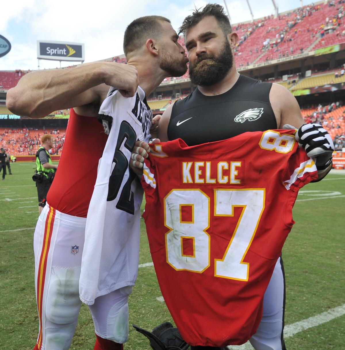 Travis Kelce kisses his brother, Philadelphia Eagles center Jason Kelce, after they exchanged jerseys