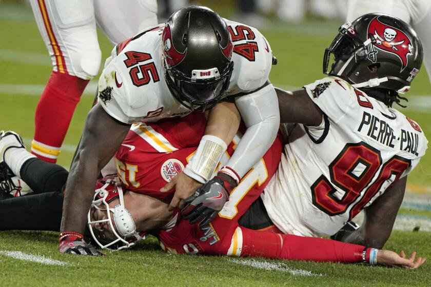 Kansas City Chiefs quarterback Patrick Mahomes is tackled by Tampa Bay linebackers Devin White (45) and Jason Pierre-Paul 