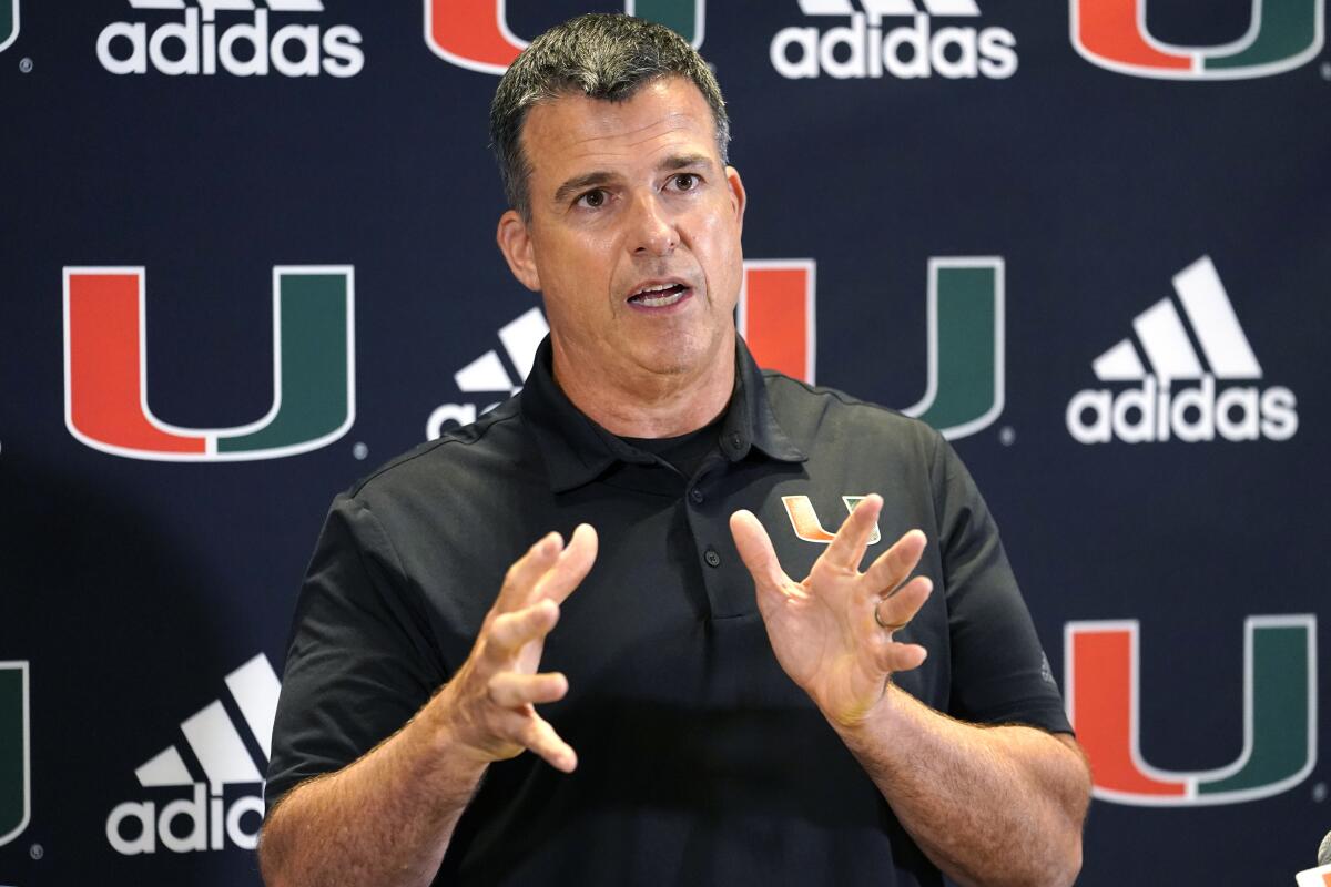 FILE - Miami head coach Mario Cristobal talks with the media at the team's NCAA college football media day, Tuesday, Aug. 2, 2022, in Coral Gables, Fla. Cristobal isn't the only coach who came home to Miami. The Hurricanes have no shortage of assistants and analysts with deep Miami ties who signed on to join Cristobal's first staff at his alma mater. (AP Photo/Lynne Sladky, File)