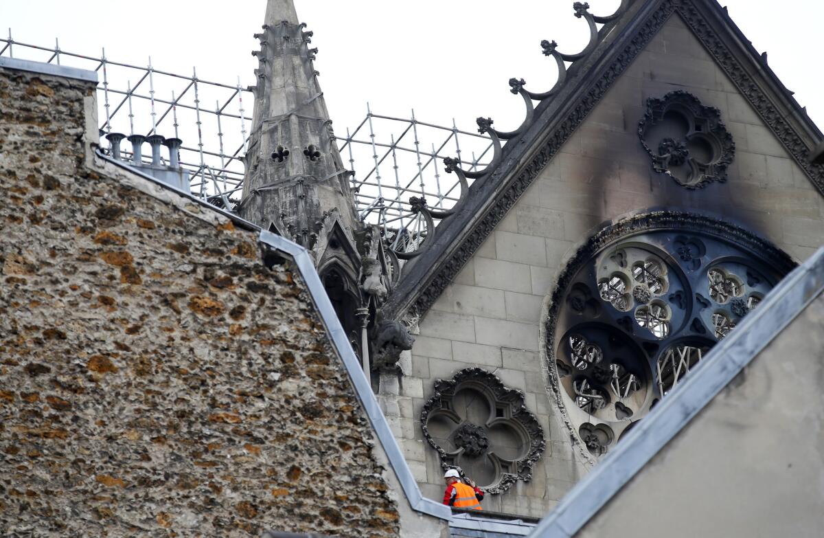 A worker atop Notre Dame Cathedral on Tuesday.