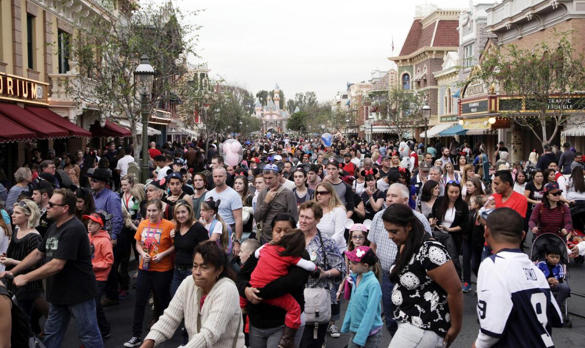 People crowd Main Street at Disneyland in Anaheim, Calif. in this file photo from Jan. 22, 2015.