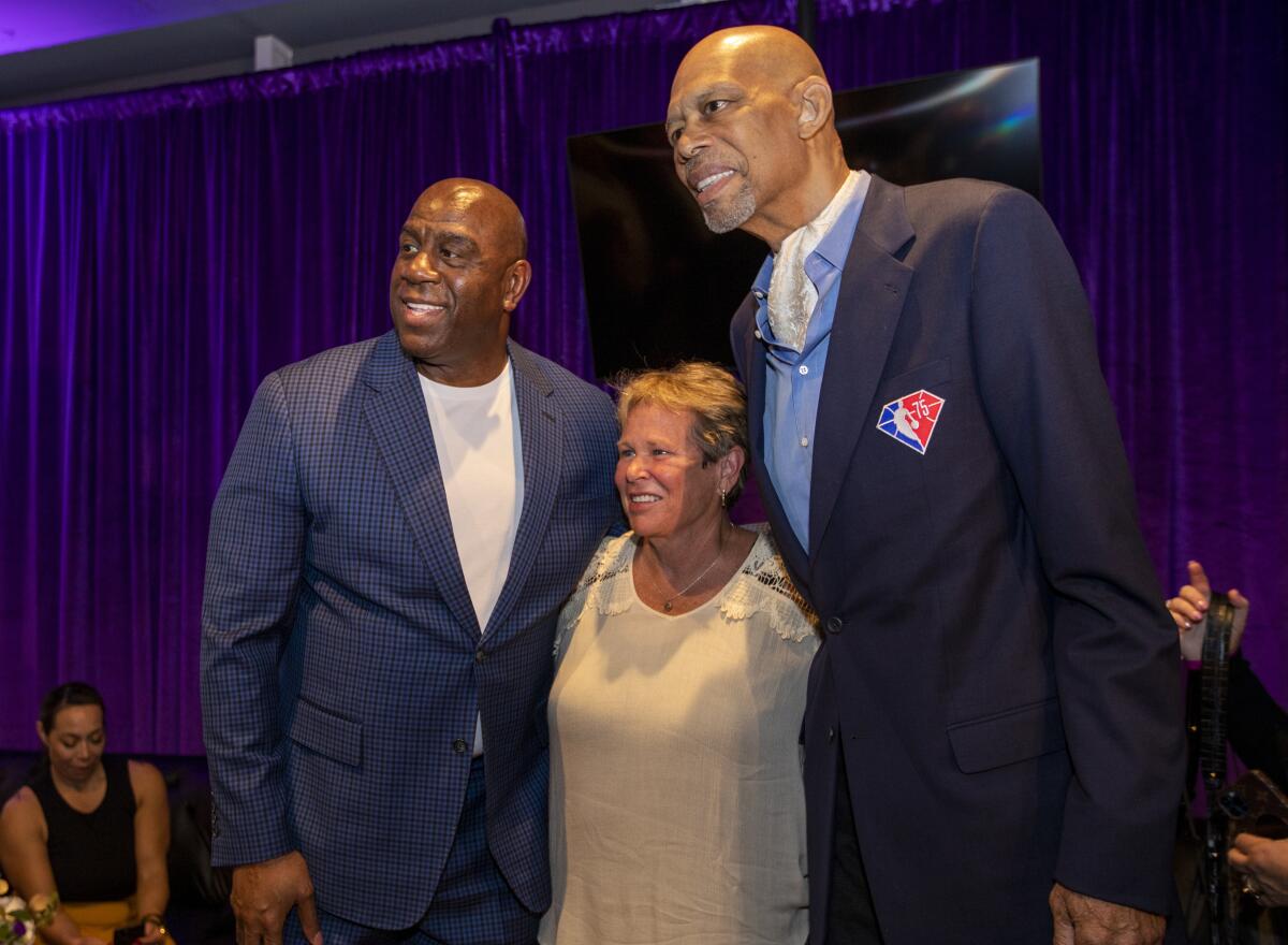 Magic Johnson, left, Ann Meyer Drysdale and Kareem Abdul-Jabbar celebrate Abdul-Jabbar's 75th birthday