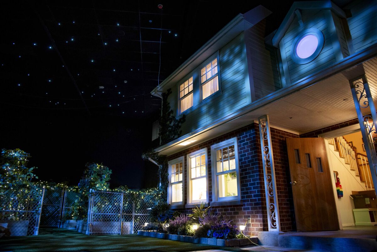 The exterior of a house is shown under a starry sky.