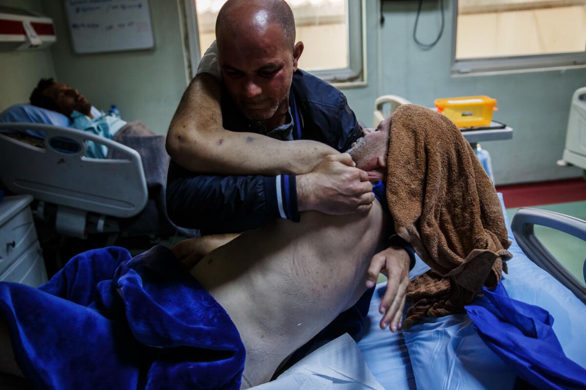 Mubashr Thanoon helps his brother Ali Thanoon get up at the West Irbil Hospital on April 1, 2017. Ali was buried under concrete for five days after an air strike, likely by U.S. coalition forces, in the Jadidah neighborhood of Mosul.