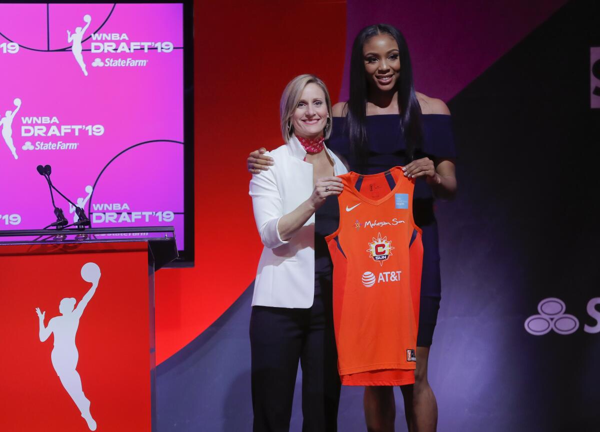 Kristine Anigwe, right, poses with WNBA COO Christy Hedgpeth in the WNBA draft on April 10, 2019, in New York.