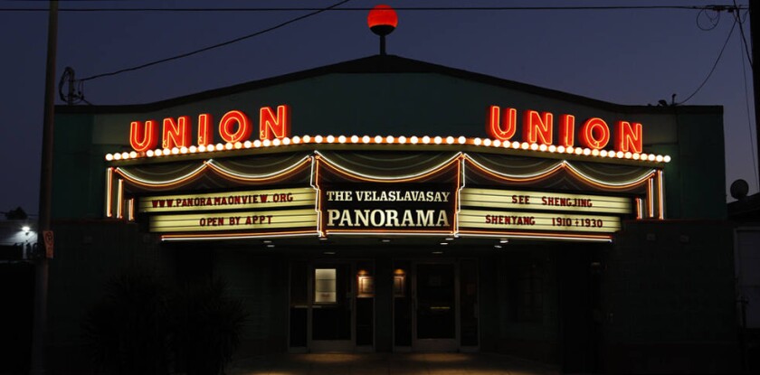 A brightly lighted  marquee at night.