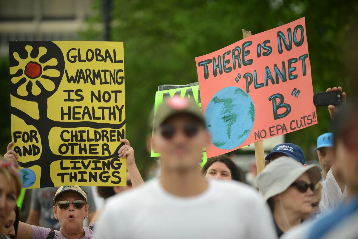 People march on April 29 in Washington, D.C., on their way to the White House to protest President Trump's environmental policies. (Astrid Riecken / Getty Images)