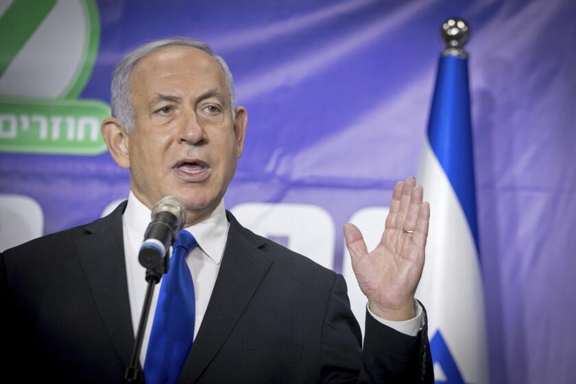 FILE - In this March 8, 2021 file photo, Israeli Prime Minister Benjamin Netanyahu, center, speaks to journalists after meeting the Israeli citizen, who is the 5 millionth person to be vaccinated in Israel, at a ceremony in Tel Aviv. An Israeli official says Netanyahu will travel to the United Arab Emirates on Thursday, March 10. It will be Netanyahu's first official trip to the Gulf Arab nation after the two countries established diplomatic relations. (Miriam Alster/Pool via AP)