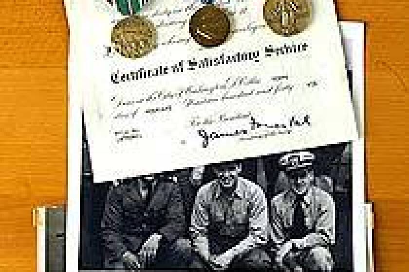 John J. Spano is pictured above, at right, with fellow sailors. His mementos include a certificate recognizing his service, medals and a D-day photo at Omaha Beach.