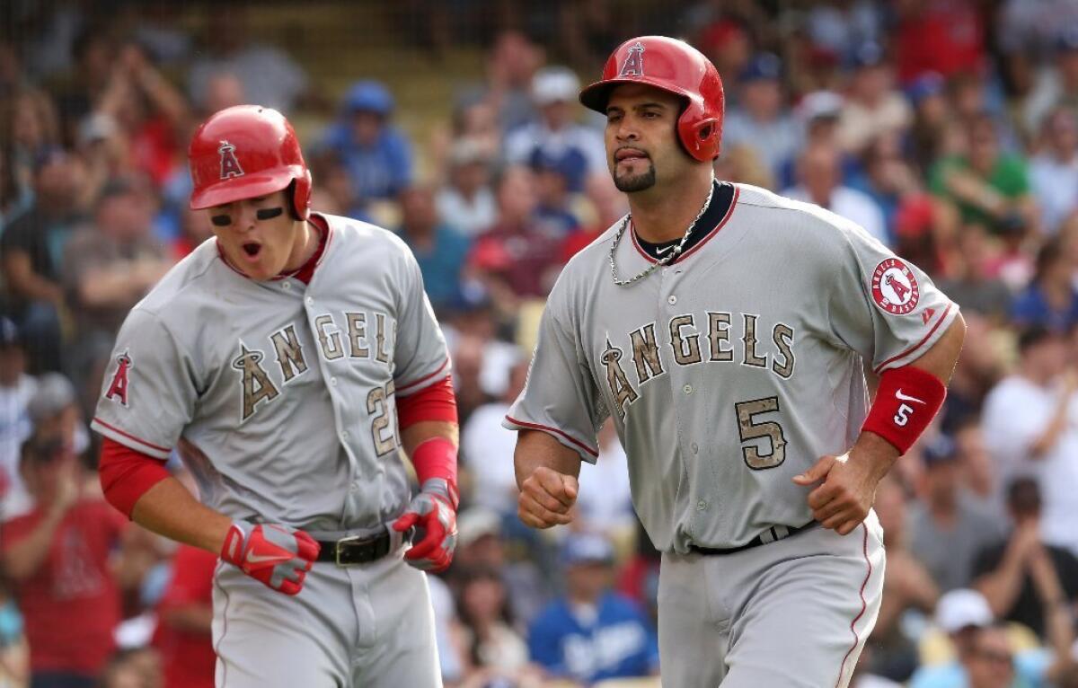 Mike Trout, left, and Albert Pujols.