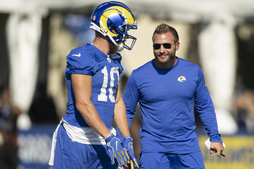 Los Angeles Rams wide receiver Cooper Kupp (10) talks to head coach Sean McVay at the NFL football team's training camp, Saturday, July 29, 2023, in Irvine, Calif. (AP Photo/Kyusung Gong)