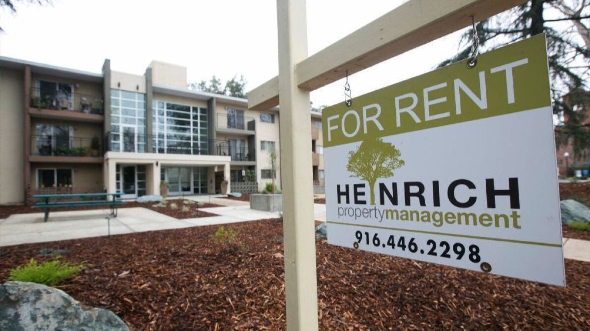 A "For Rent" sign is posted outside an apartment building in Sacramento on Jan. 8.