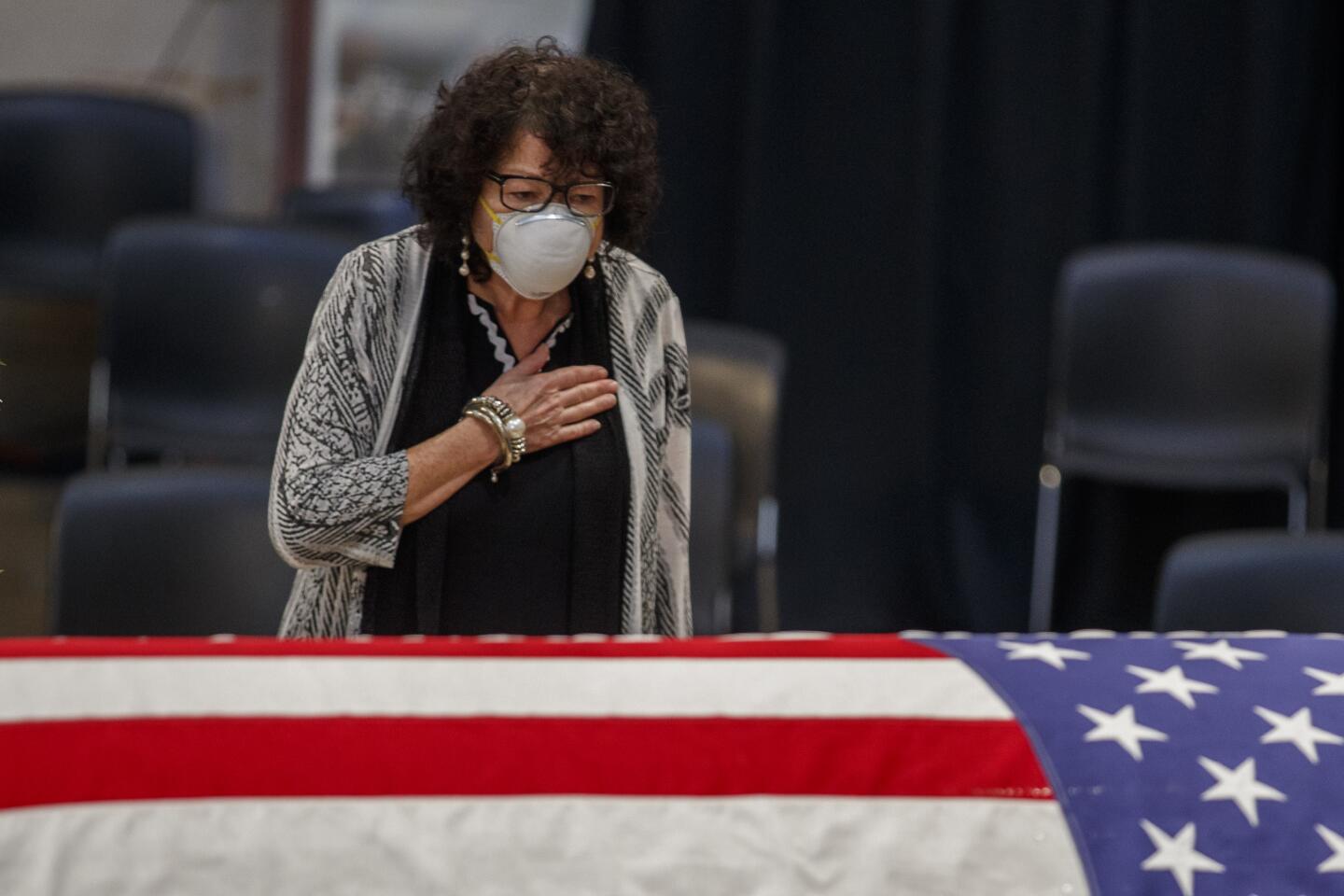Supreme Court associate justice Sonia Sotomayor pauses at the flag-draped casket of Rep. John Lewis, D-Ga., as he lies in state in the Rotunda of the U.S. Capitol in Washington Monday.