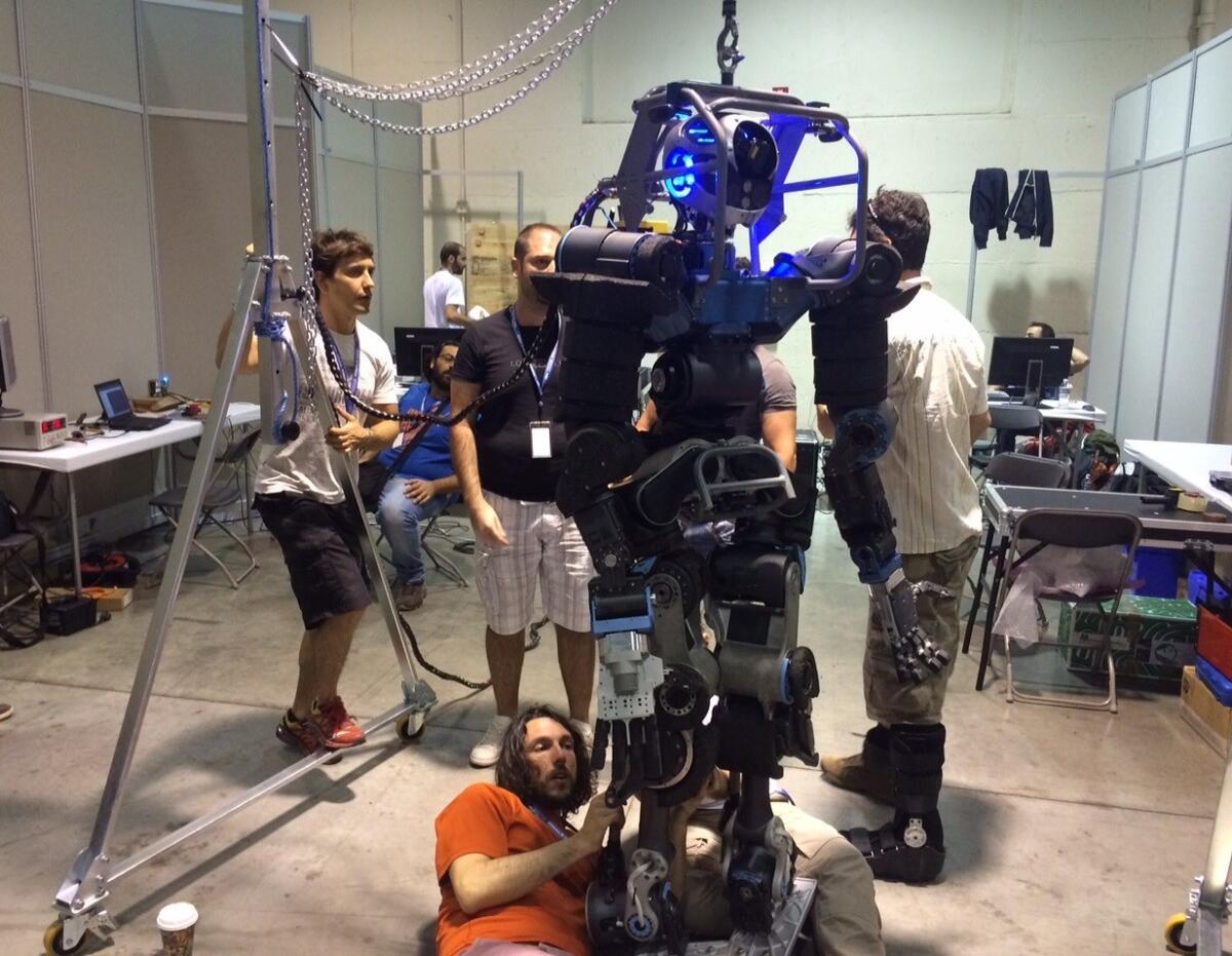 The Italian Institute of Technology team works on their robot, WALK-MAN, a few days before the DARPA Robotics Challenge being held Friday and Saturday at the Fairplex in Pomona.