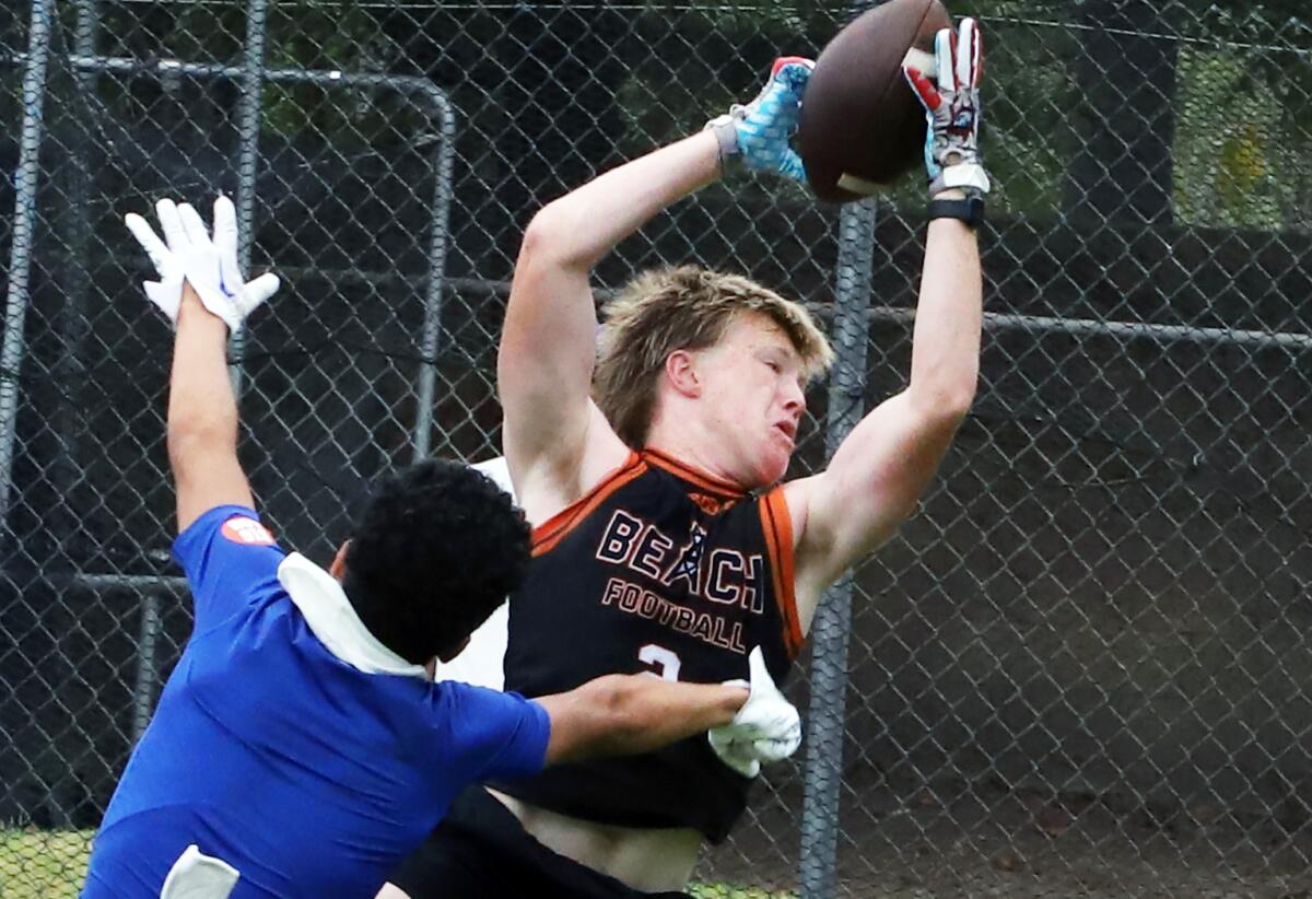 Huntington Beach's Hunter Gray makes a leaping catch against Charter Oak on Saturday.