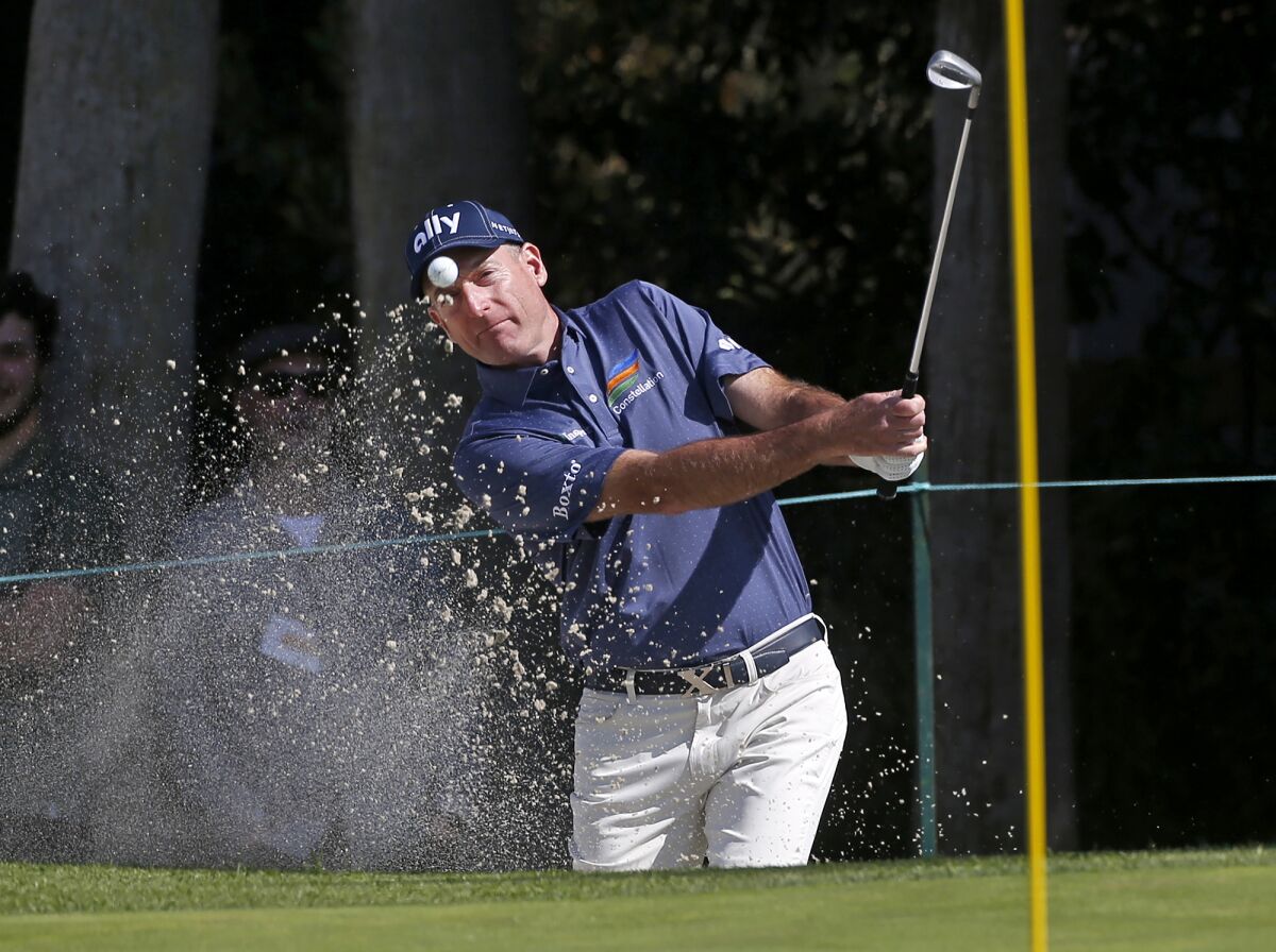Jim Furyk hits out of a green-side bunker on the 15th hole during the Hoag Classic at Newport Beach County Club on Friday.