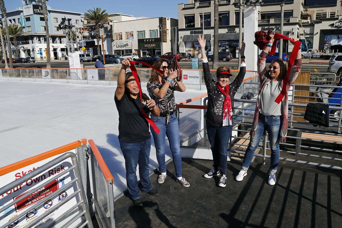 Elected officials celebrate during a soft opening for the Surf City Winter Wonderland ice skating rink on Wednesday.