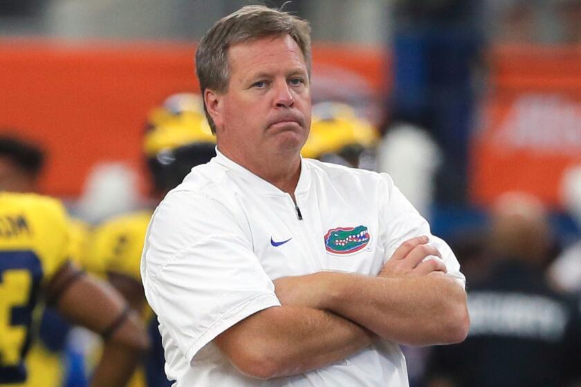 FILE - This is a Sept. 2, 2017, file photo showing Florida head coach Jim McElwain watching his team warm up before an NCAA college football game against Michigan, in Arlington, Texas. McElwain says players and families have received death threats amid the teamâs struggles, adding âthereâs a lot of hate in this world and a lot of anger.â McElwain declined to say Monday, Oct. 23, 2017, whether he personally received death threats.(AP Photo/Tony Gutierrez, File)