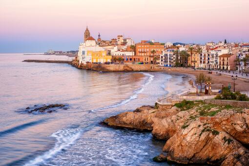 A photo of sand beach and historical Old Town in Mediterranean resort Sitge