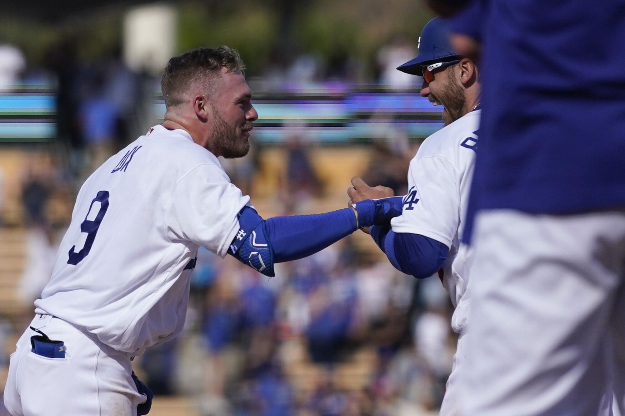 Gavin Lux, left, celebrates with Dodgers teammate Cody Bellinger after hitting a walk-off double in the ninth inning.