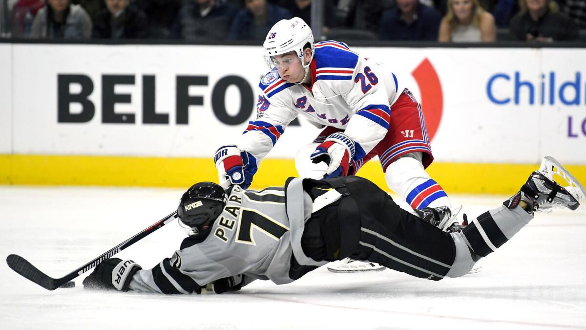 Left wing Tanner Pearson, much like the Kings' offense, falls flat on the ice against left wing Jimmy Vesey and the New York Rangers during their game Saturday night. (Mark J. Terrill / Associated Press)