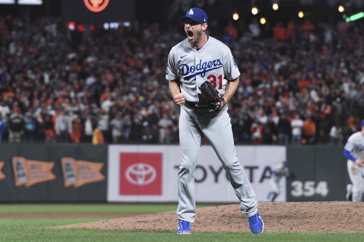 Dodgers pitcher Max Scherzer reacts after striking out San Francisco's Wilmer Flores.