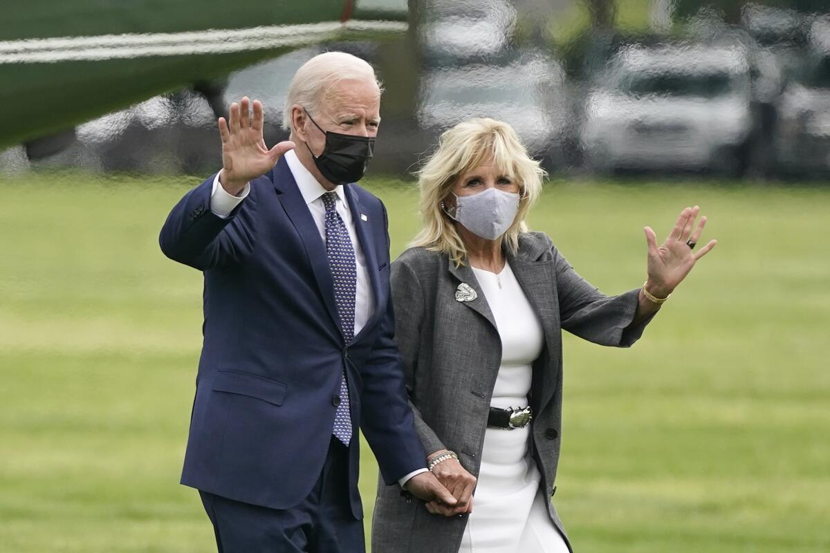 President Joe Biden and first lady Jill Biden wave after stepping off Marine One on the Ellipse near the White House, Monday, May 3, 2021, in Washington. The Biden's traveled Monday to coastal Virginia to promote his plans to increase spending on education and children, part of his $1.8 trillion families proposal announced last week. (AP Photo/Patrick Semansky)