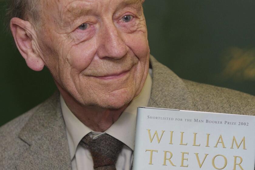 William Trevor holds a copy of his book "The Story of Lucy Gault" in 2002.