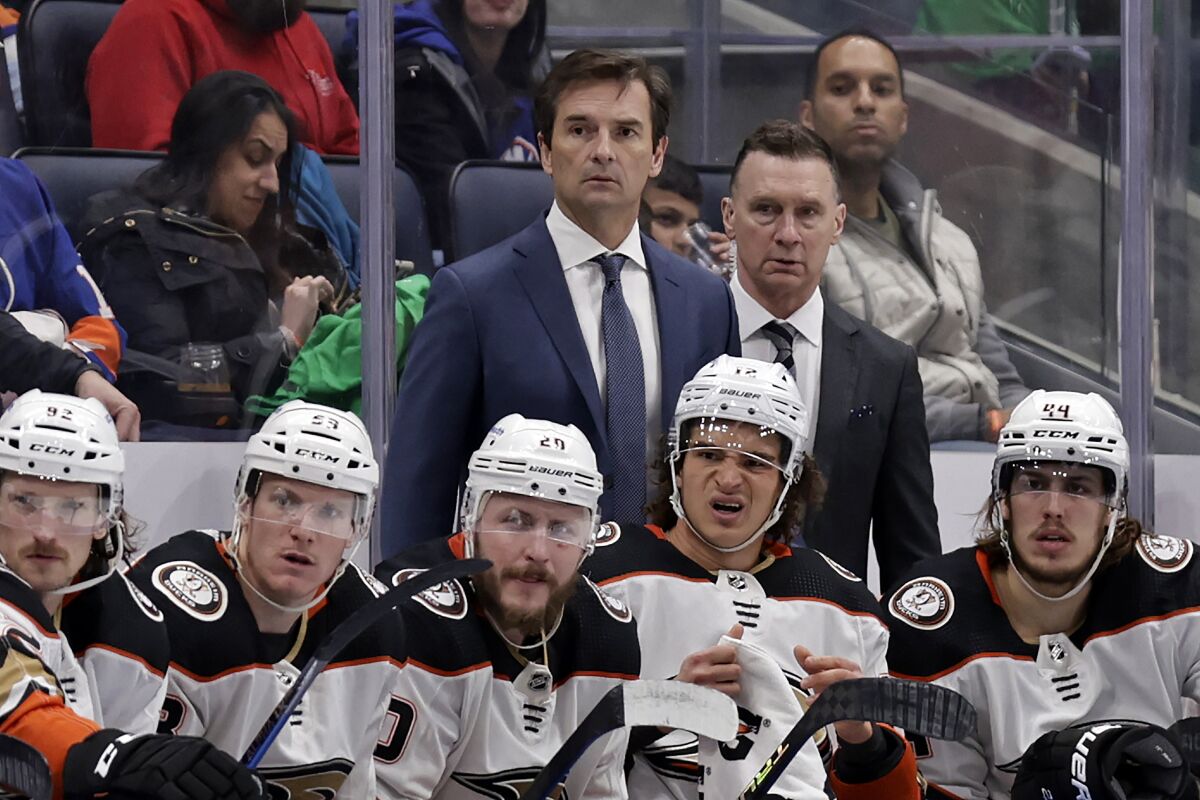 Anaheim Ducks head coach Dallas Eakins, center top, looks on in the second period of an NHL hockey game against the New York Islanders, Sunday, March 13, 2022, in Elmont, N.Y. (AP Photo/Adam Hunger)