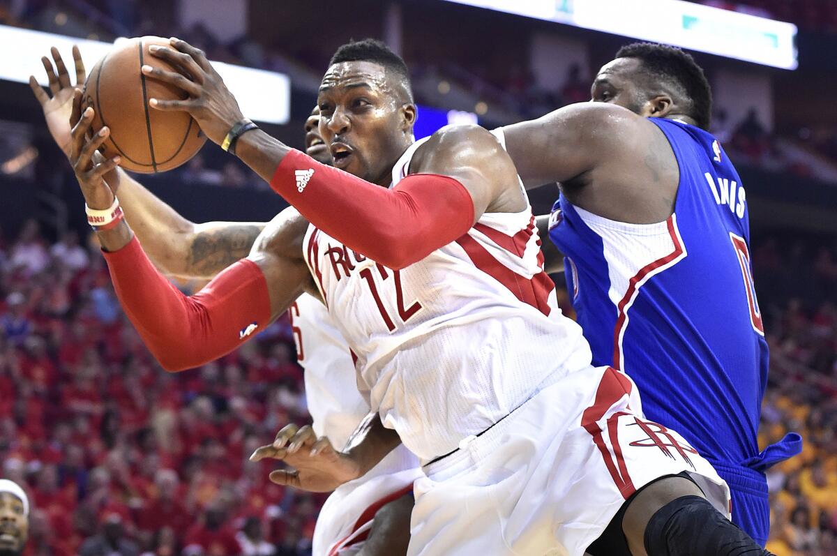 Houston big man Dwight Howard grabs a rebound from Glen Davis during the Clippers' loss to the Rockets, 124-103, in Game 5 of their second round playoff series.