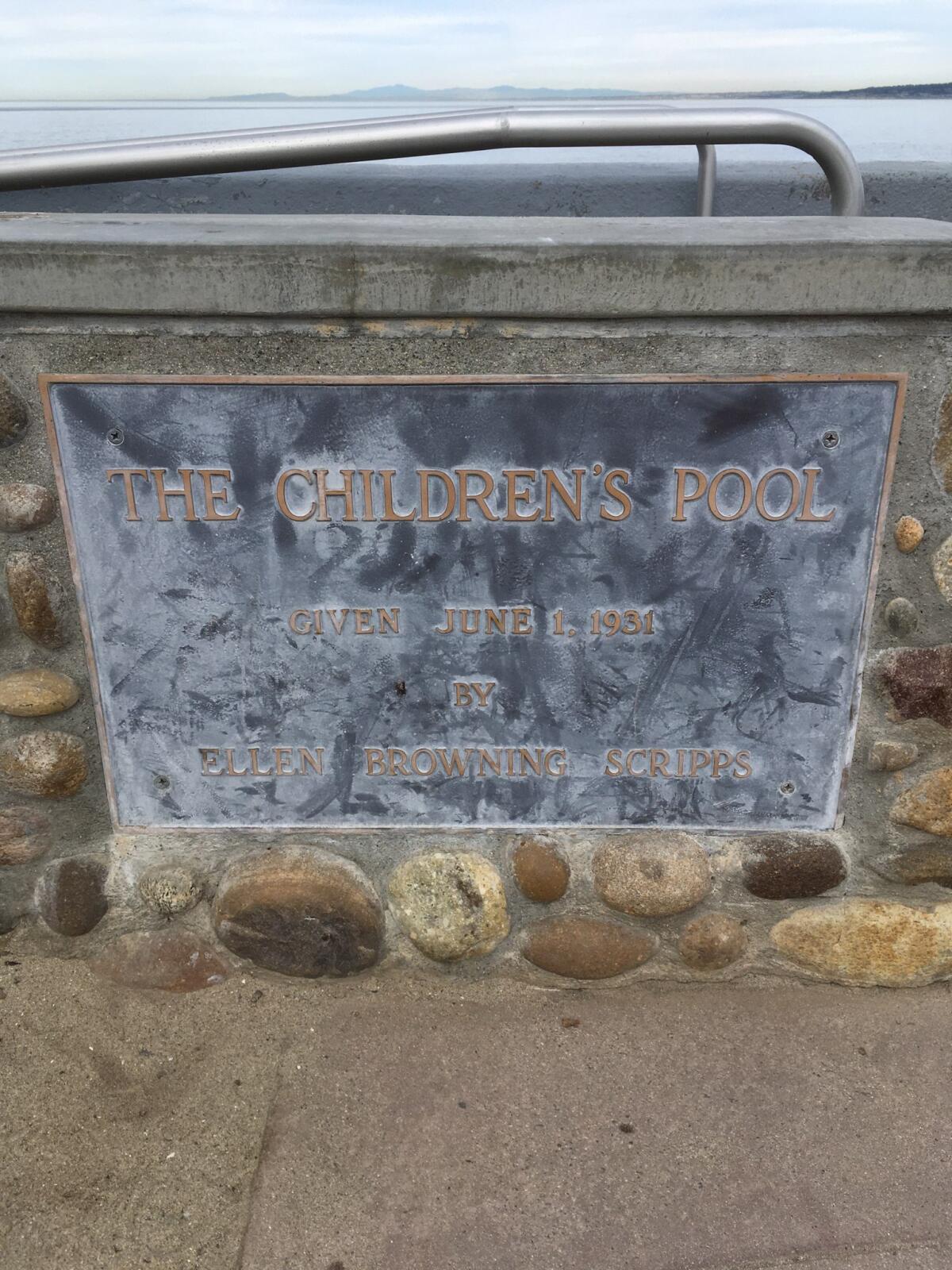 A discolored plaque at the Children's Pool in La Jolla is pictured before it was cleaned.