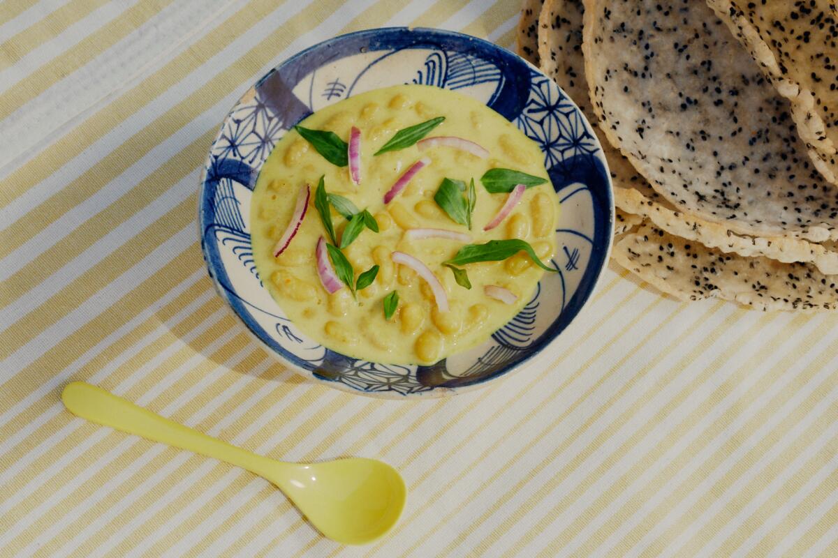 A bowl of white beans with coconut lemongrass broth 