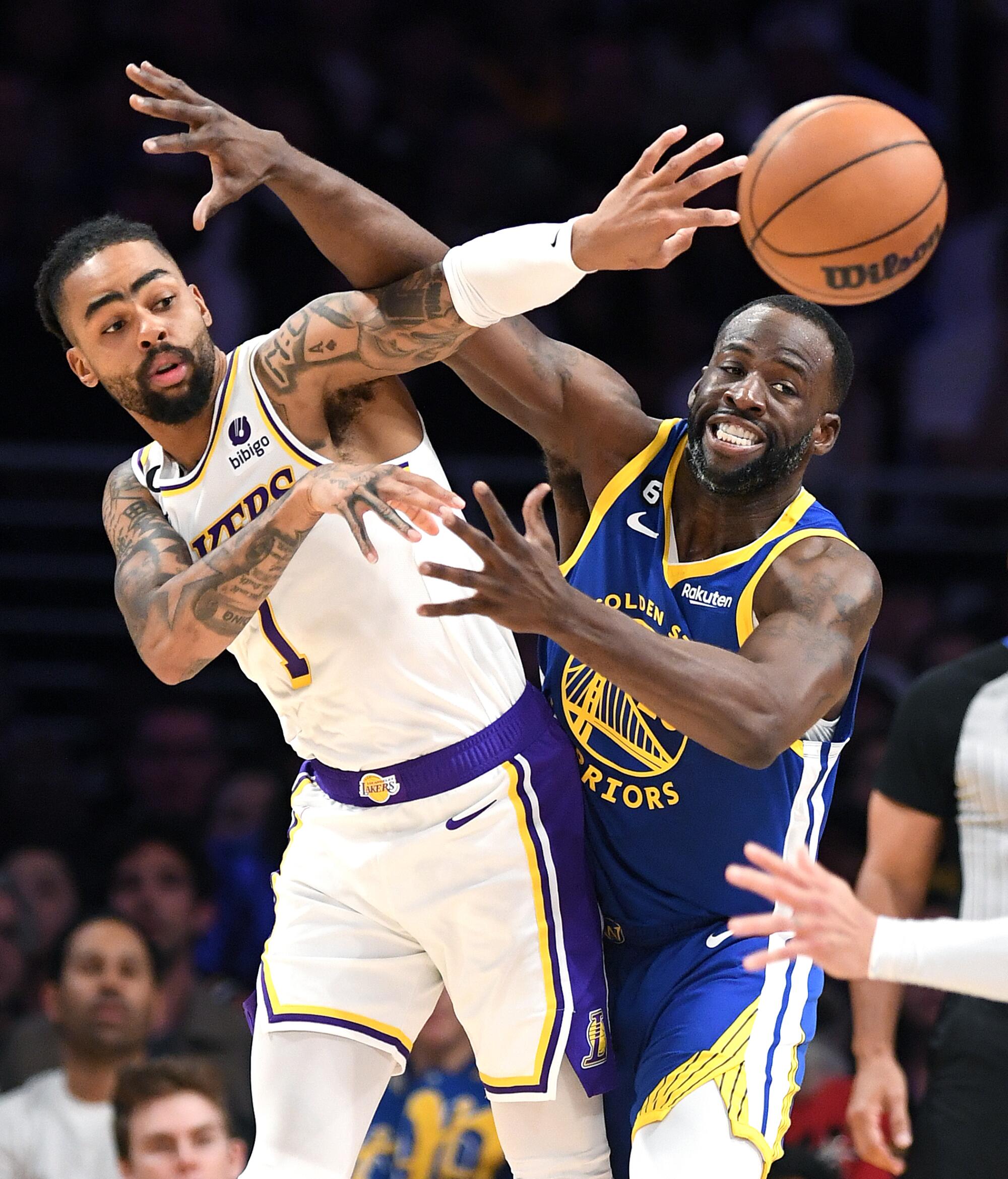 Los Angeles, California May 6, 2023-Lakers D'Angelo Russell gets a pass off in front of Warriors Draymond Green.