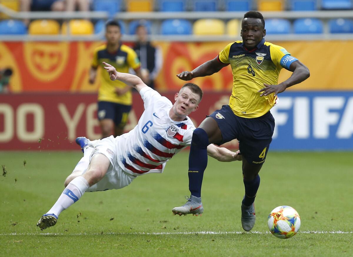 United States' Chris Durkin, left, and Ecuador's Jhon Espinoza challenge for the ball during the quarter final match between USA and Ecuador at the U20 World Cup soccer in Gdynia, Poland, Saturday, June 8, 2019.
