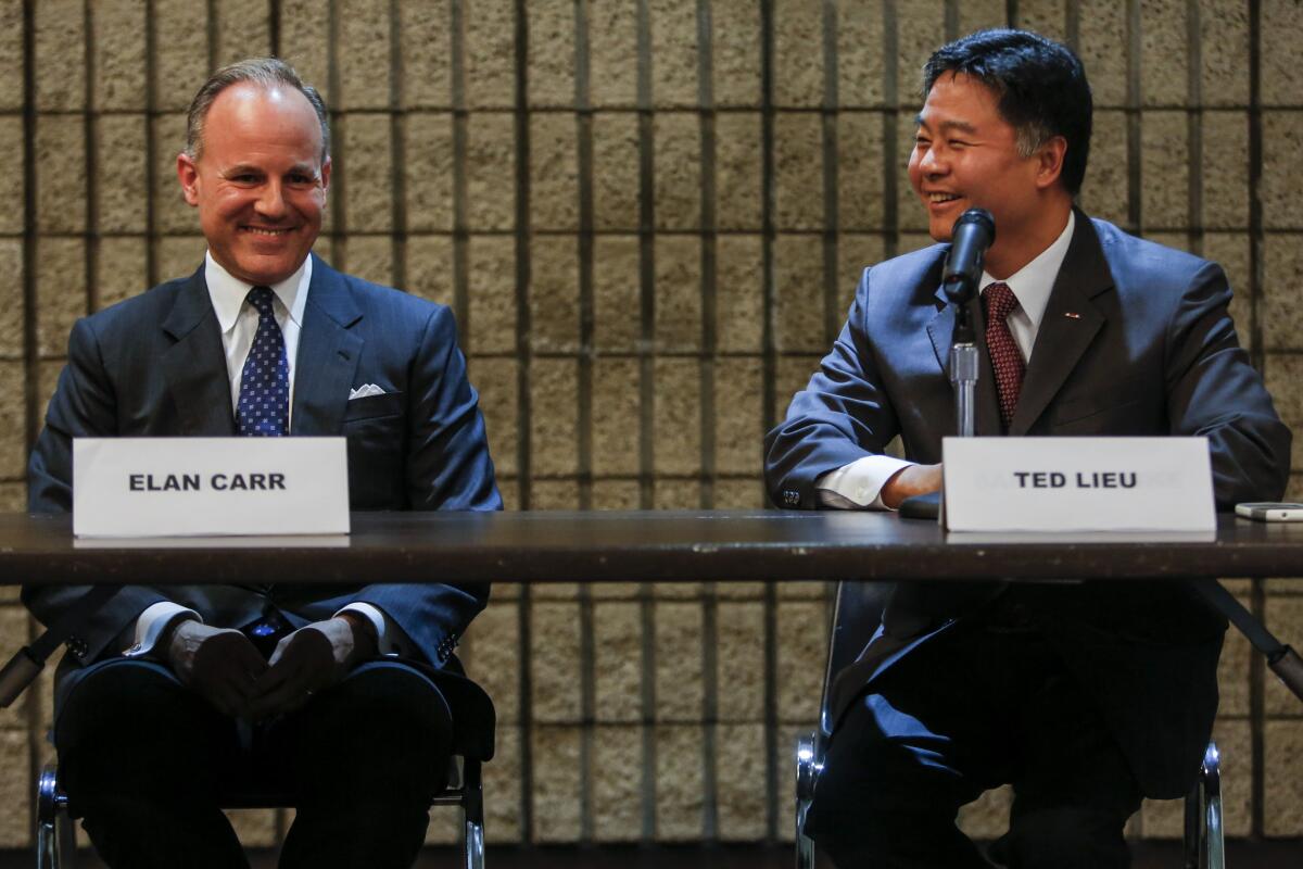 Congressional candidates Elan S. Carr, left, and state Sen. Ted Lieu (D-Torrance) share a light moment at a candidates forum in Rancho Palos Verdes last week.