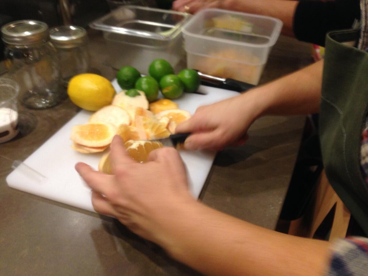Cutting up grapefruit to make marmalade.