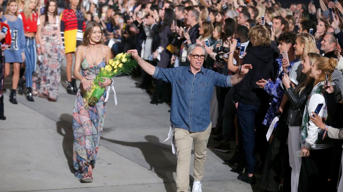 Gigi Hadid and Tommy Hilfiger wave to the crowd at the end of their Tommy X Gigi show in Venice Beach on Feb. 8.