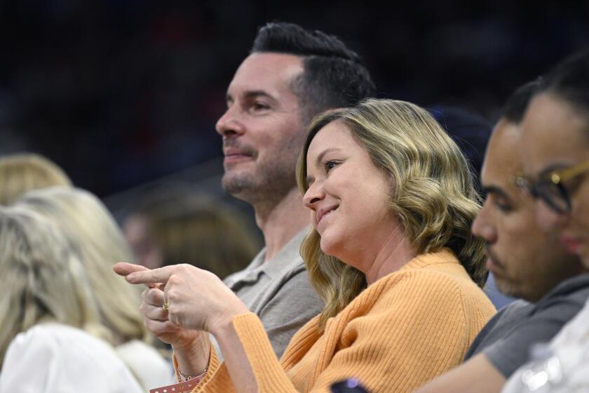 Former Orlando Magic guard JJ Redick, center, and his wife, Chelsea Kilgore.