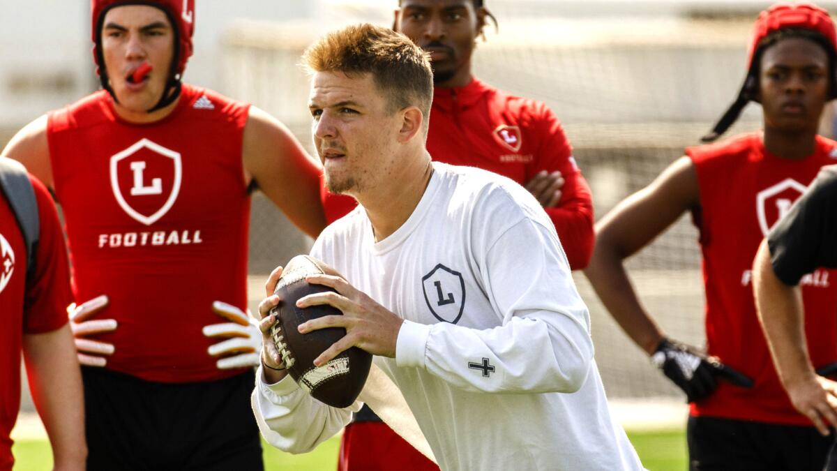 Orange Lutheran quarterback Ryan Hilinski checks for a receiver downfield during Battle at the Beach seven-on-seven passing tournament at Huntington Beach Edison on Saturday.