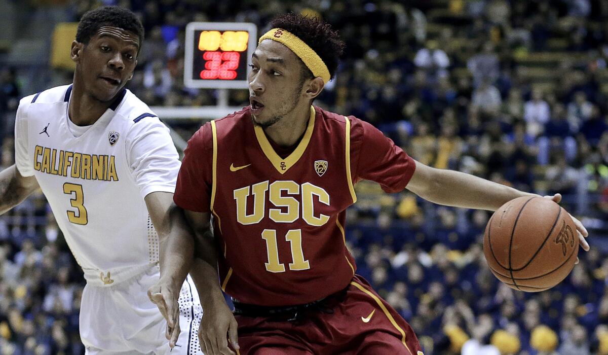 USC guard Jordan McLaughlin (11) tries to drive past California guard Tyrone Wallace in the first half Thursday night in Berkeley.