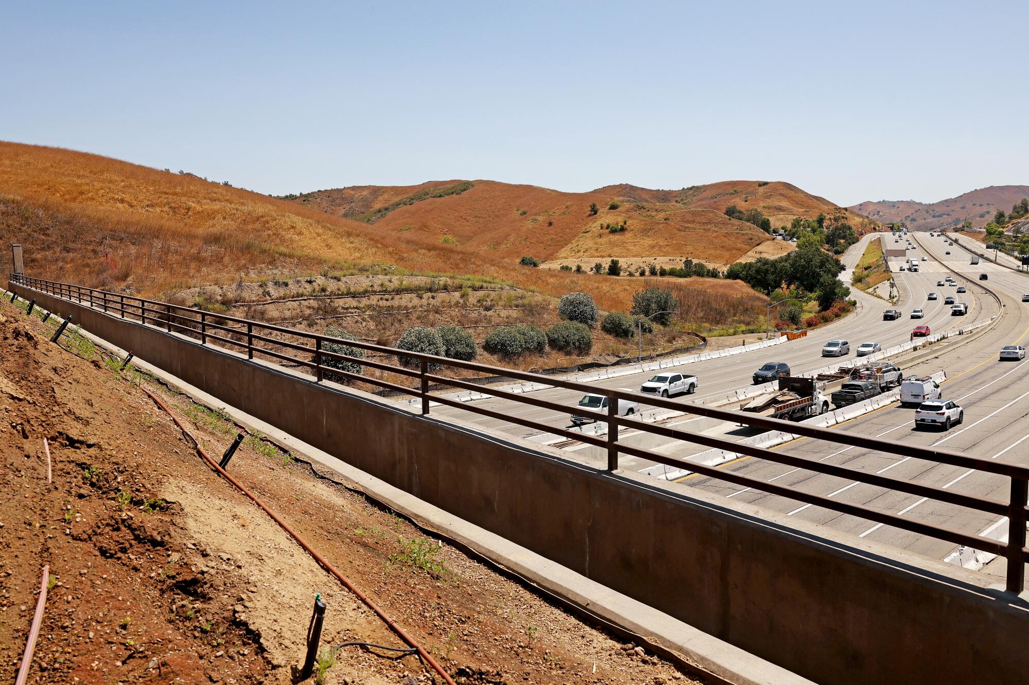 Overlooking the 101 freeway to the northeast, with cars passing below, from atop the Wallis Annenberg Wildlife Crossing.